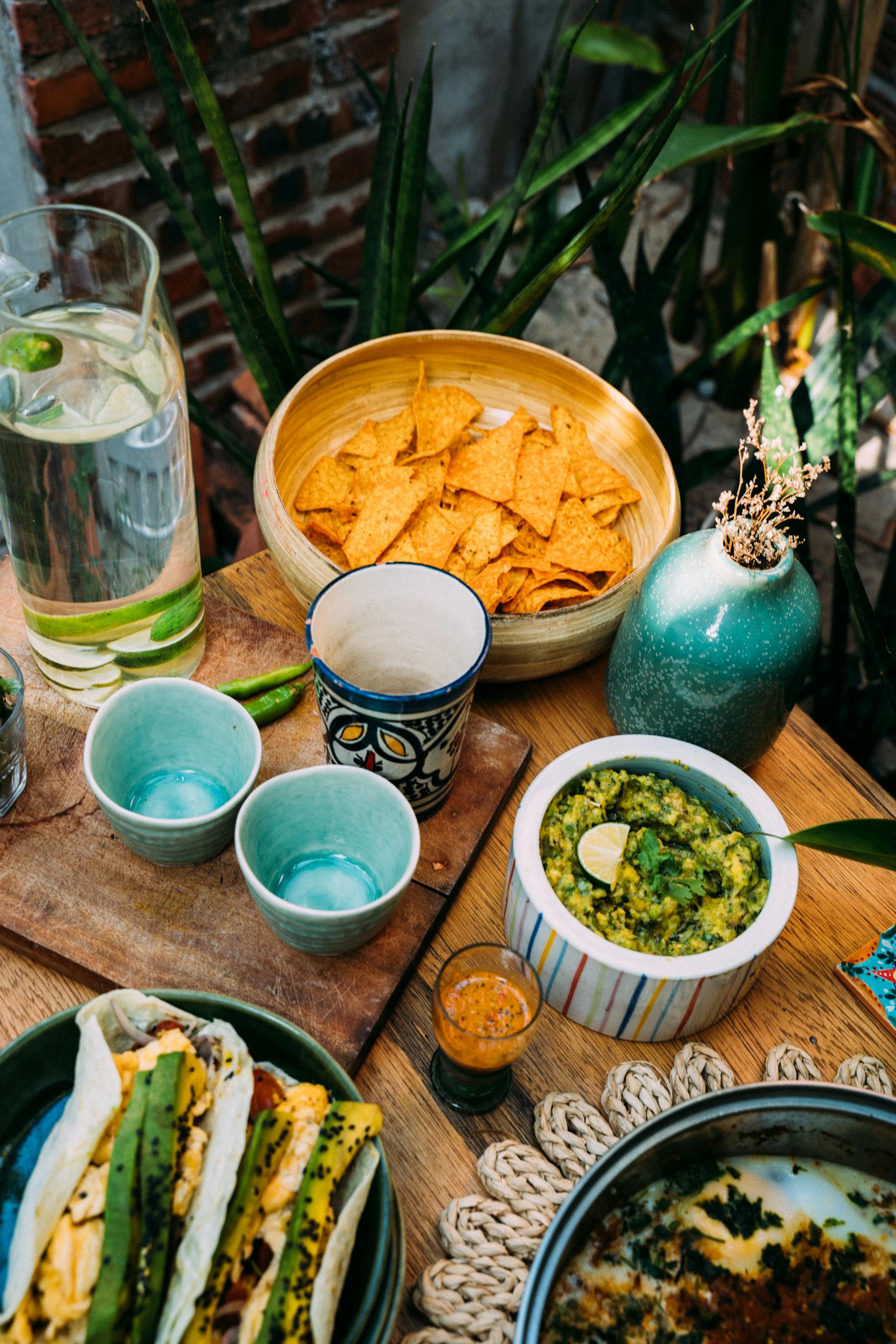 A vibrant display of Mexican food including tacos, guacamole, and chips. Perfect for Cinco de Mayo.